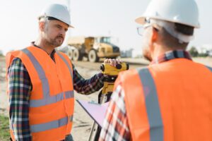 construction workers setting equipment in the middle of the road structure